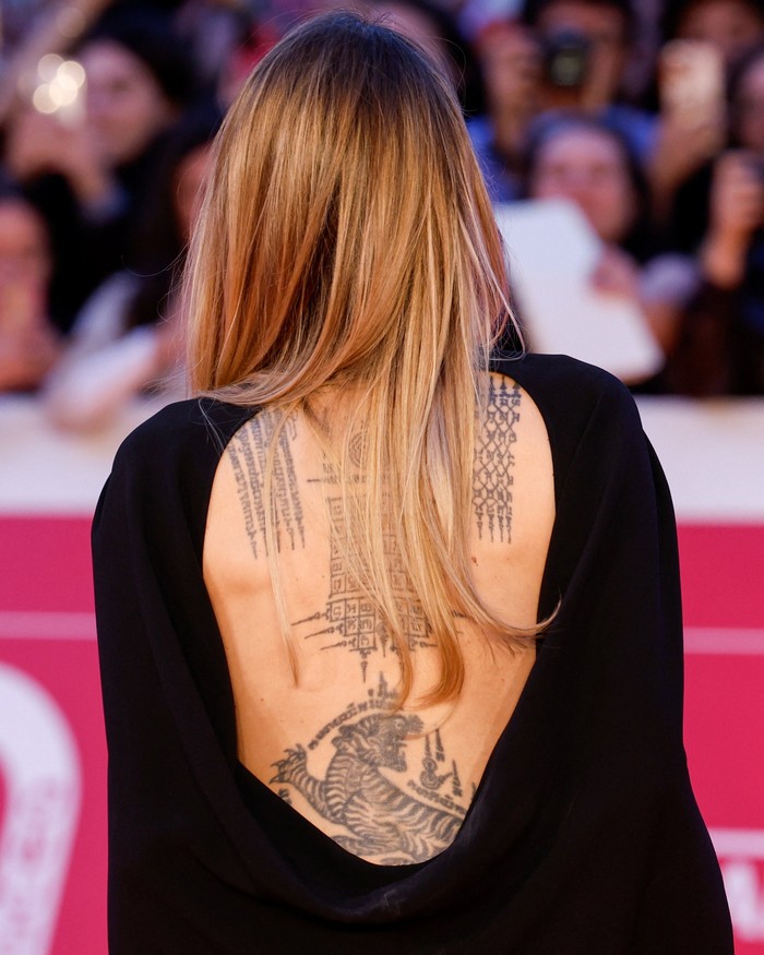 Cast member Angelina Jolie speaks to reporters as she arrives for the premiere of 