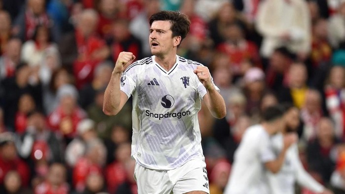 Manchester Uniteds English defender #05 Harry Maguire celebrates scoring the teams second goal during the English Premier League football match between Liverpool and Manchester United at Anfield in Liverpool, north west England on October 19, 2025. (Photo by PETER POWELL / AFP) / RESTRICTED TO EDITORIAL USE. No use with unauthorized audio, video, data, fixture lists, club/league logos or live services. Online in-match use limited to 120 images. An additional 40 images may be used in extra time. No video emulation. Social media in-match use limited to 120 images. An additional 40 images may be used in extra time. No use in betting publications, games or single club/league/player publications. /