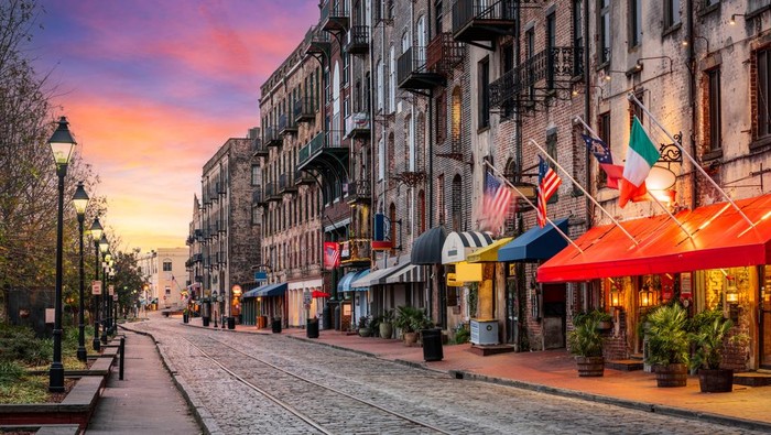 Savannah, Georgia, USA bars and restaurants on River Street at dawn.