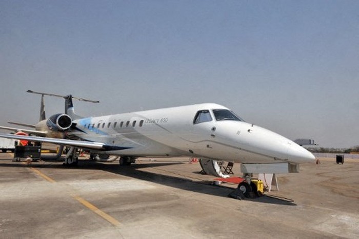A Legacy 650 Embraer aircraft stands parked on the tarmac at the India Aviation 2012 show at Begumpet Airport in Hyderabad on March 15, 2012. The third edition of India Aviation 2012, a five day event runs from March 14-18, where some 250 international companies will showcase the latest global aerospace technology, offering opportunities for them to do business in India. AFP PHOTO / Noah SEELAM (Photo by NOAH SEELAM / AFP)