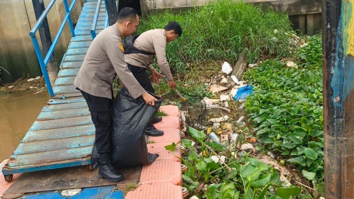 Polisi saat bersih-bersih sampah di tepian Sungai Siak. (Dok Polresta Pekanbaru)