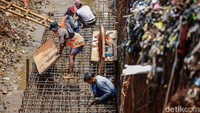 Pekerja menyelesaikan pengerjaan rekonstruksi jalan di Jalan Pitara, Depok, Kamis (23/10/2025).