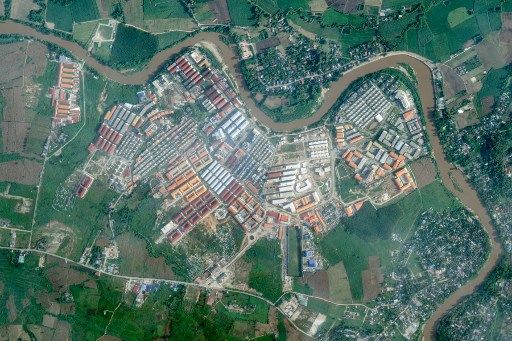 (FILES) This photo taken on September 17, 2025 shows advertisements for gambling sites and what appears to be Starlink satellite dishes on the roofs of buildings at KK Park complex in Myanmar's eastern Myawaddy township, as pictured from Mae Sot district in Thailand's border province of Tak. More than 600 people fled one of Myanmar's most notorious scam centres and crossed into Thailand, a Thai provincial official told AFP on October 23, after a military raid on the compound. Sawanit Suriyakul Na Ayutthaya, deputy governor of Tak province on the Myanmar border, told AFP 