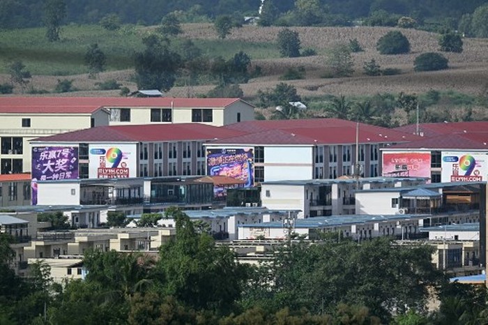 (FILES) This photo taken on September 17, 2025 shows advertisements for gambling sites and what appears to be Starlink satellite dishes on the roofs of buildings at KK Park complex in Myanmars eastern Myawaddy township, as pictured from Mae Sot district in Thailands border province of Tak. More than 600 people fled one of Myanmars most notorious scam centres and crossed into Thailand, a Thai provincial official told AFP on October 23, after a military raid on the compound. Sawanit Suriyakul Na Ayutthaya, deputy governor of Tak province on the Myanmar border, told AFP 