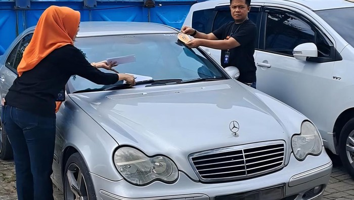 Petugas tempel stiker ke mobil telat bayar pajak (dok. Samsat Serang) Petugas tempel stiker ke mobil telat bayar pajak (dok. Samsat Serang)