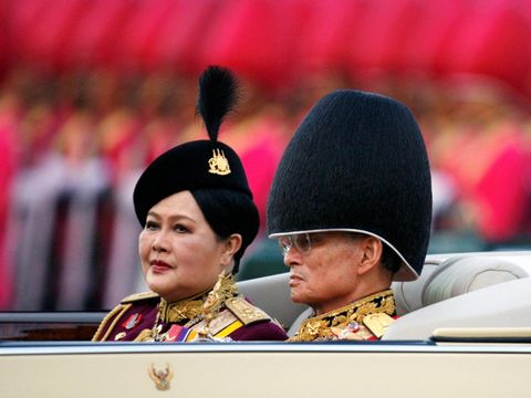 THAILAND-QUEENMOTHER/  Thailand's King Bhumibol Adulyadej reviews a parade with Thailand's Queen Mom Rajawongse Sirikit to mark his 79th birthday in Bangkok, December 2, 2006. REUTERS/Chaiwat Subprasom/File Photo