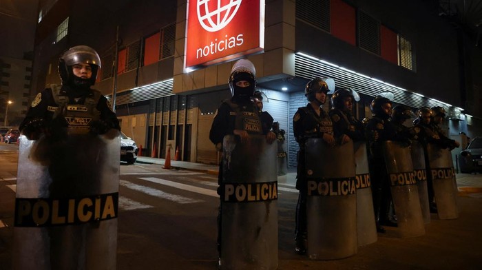 Police officers stand guard outside the building of the television channel America Television as demonstrators take part in a protest against rising crime, economic instability, and government corruption, in Lima, Peru, October 25, 2025. REUTERS/Sebastian Castaneda