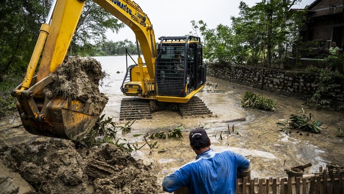 Perbaikan Tanggul Jebol Sungai Gandam Dikebut Usai Air Meluap dari Kendeng Petugas Balai Besar Wilayah Sungai (BBWS) Pemali Juana menggunakan alat berat memperbaiki tanggul Sungai Gandam yang jebol di Desa Ketitang Wetan, Batangan, Kabupaten Pati, Jawa Tengah, Selasa (28/10/2025). Badan Penanggulangan Bencana Daerah (BPBD) Kabupaten Pati menjelaskan bahwa jebolnya tanggul pada Jumat (24/10) terjadi di tiga titik aliran Sungai Gandam yang melintasi tiga desa di Kecamatan Batangan itu disebabkan oleh meningkatnya debit air sungai yang tidak mampu ditampung, akibat aliran deras dari kawasan Pegunungan Kendeng. ANTARA FOTO/Aprillio Akbar/bar