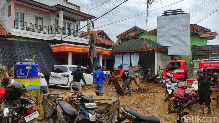Warga Kampung Tugu saling membantu mengevakuasi motor dan perabot rumah tangga yang rusak akibat terendam lumpur. Banyak warga memilih tetap bertahan di rumah pascabanjir Warga Kampung Tugu saling membantu mengevakuasi motor dan perabot rumah tangga yang rusak akibat terendam lumpur. Banyak warga memilih tetap bertahan di rumah pascabanjir