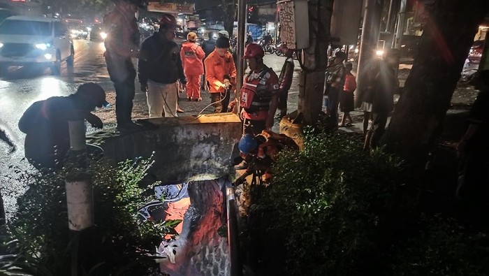 Warga hanyut di gorong-gorong Petugas mencari warga yang hanyut ke gorong-gorong di Blimbing, Kota Malang.