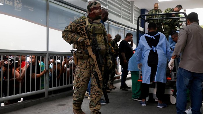 People watch as members of the military police bring bodies of dead people to a hospital, on the day of a police operation against drug trafficking at the favela do Penha, in Rio de Janeiro, Brazil October 28, 2025. REUTERS/Aline Massuca