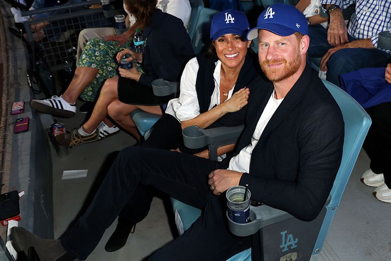 LOS ANGELES, CA - OCTOBER 28:  Prince Harry, Duke of Sussex and Meghan, Duchess of Sussex pose for a photo during Game Four of the 2025 World Series presented by Capital One between the Toronto Blue Jays and the Los Angeles Dodgers at Dodger Stadium on Tuesday, October 28, 2025 in Los Angeles, California. (Photo by Joe Scarnici/MLB Photos via Getty Images)