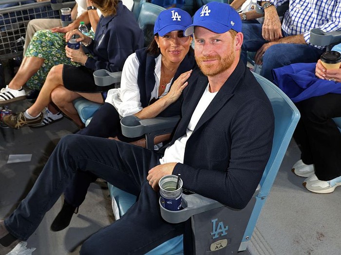 LOS ANGELES, CA - OCTOBER 28:  Prince Harry, Duke of Sussex and Meghan, Duchess of Sussex pose for a photo during Game Four of the 2025 World Series presented by Capital One between the Toronto Blue Jays and the Los Angeles Dodgers at Dodger Stadium on Tuesday, October 28, 2025 in Los Angeles, California. (Photo by Joe Scarnici/MLB Photos via Getty Images)