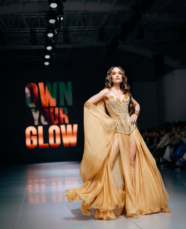 Cinta Laura tampil sebagai bintang utama di hari terakhir JFW 2026, memancarkan auranya dengan gaun emas berkilau rancangan Ivan Gunawan yang dibuat khusus untuk brand sabun mandi Lux. Foto: Instagram/@claurakiehl