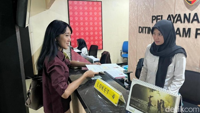 Petugas memberikan SKCK kepada pemohon di Yanmin Ditintelkam Polda Jatim