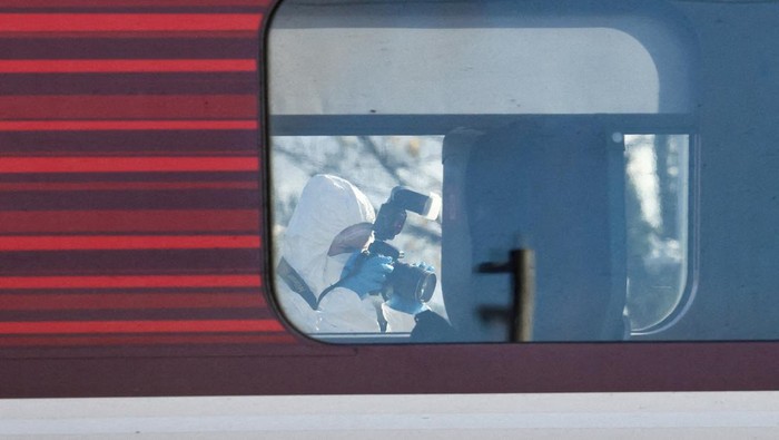 A forensic officer takes pictures of the London North Eastern Railway (LNER) train where a series of stabbings took place, at a platform at Huntingdon Station, near Cambridge, Britain, November 2, 2025. REUTERS/Jack Taylor