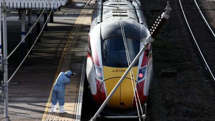A forensic officer takes pictures of the London North Eastern Railway (LNER) train where a series of stabbings took place, at a platform at Huntingdon Station, near Cambridge, Britain, November 2, 2025. REUTERS/Jack Taylor