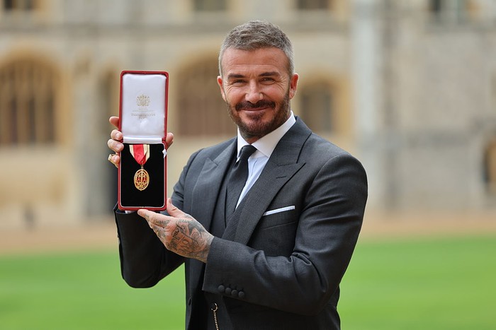 WINDSOR, ENGLAND - NOVEMBER 4: Sir David Beckham poses with his wife Lady Victoria after he was made a Knight Bachelor at an investiture ceremony at Windsor Castle on November 4, 2025 in Windsor, England. (Photo by Andrew Matthews - Pool/Getty Images)