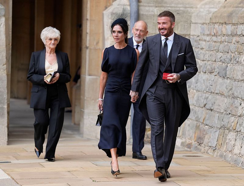 WINDSOR, ENGLAND - NOVEMBER 4: Sir David Beckham poses with his wife Lady Victoria after he was made a Knight Bachelor at an investiture ceremony at Windsor Castle on November 4, 2025 in Windsor, England. (Photo by Andrew Matthews - Pool/Getty Images)