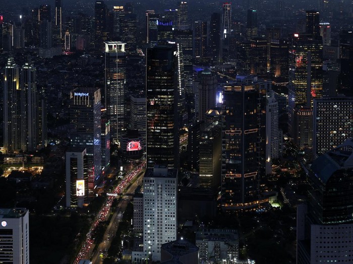 High-rise buildings are illuminated in the evening in Jakartas business district, Indonesia, November 4, 2025. REUTERS/Willy Kurniawan