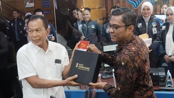 PPS Direktur Utama Bank Sumsel Babel Festero Mohamad Papeko (Baju Batik) menyerahkan cindera mata ke nasabah