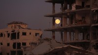 The Beaver Moon supermoon rises above destroyed buildings amid a ceasefire between Israel and Hamas, in Gaza City, November 5, 2025. REUTERS/Dawoud Abu Alkas