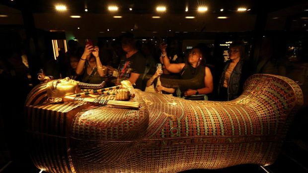 Pengunjung melihat peti mati emas Firaun Mesir kuno Tutankhamun pada hari pertama pengunjung setelah pembukaan resmi Museum Agung Mesir (GEM), dekat kompleks piramida Giza, di Giza, Mesir, 4 November 2025. (REUTERS/Mohamed Abd El Ghany)