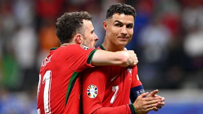 FRANKFURT AM MAIN, GERMANY - JULY 01: Diogo Jota and Cristiano Ronaldo of Portugal celebrate following the teams victory in the penalty shoot out during the UEFA EURO 2024 round of 16 match between Portugal and Slovenia at Frankfurt Arena on July 01, 2024 in Frankfurt am Main, Germany. (Photo by Stu Forster/Getty Images)