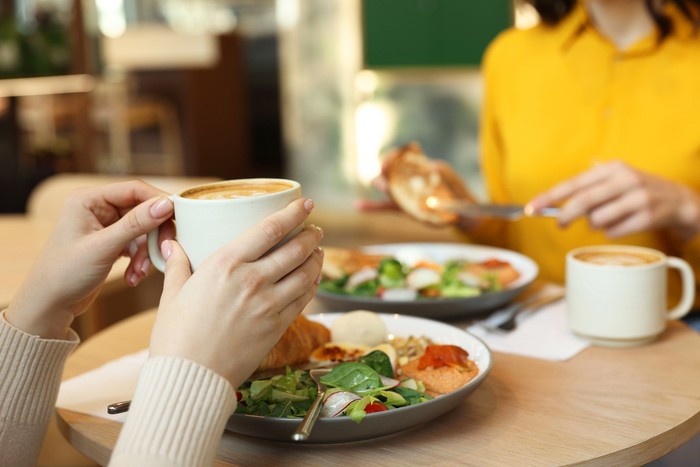 Women having tasty breakfast in cafe, closeup