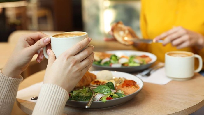 Women having tasty breakfast in cafe, closeup