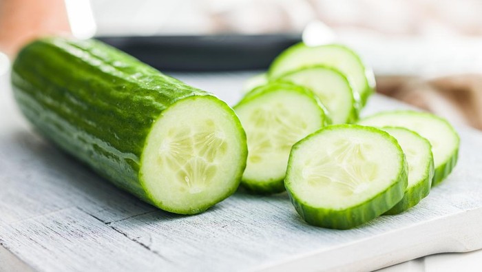 Sliced fresh green cucumber on the cutting board.