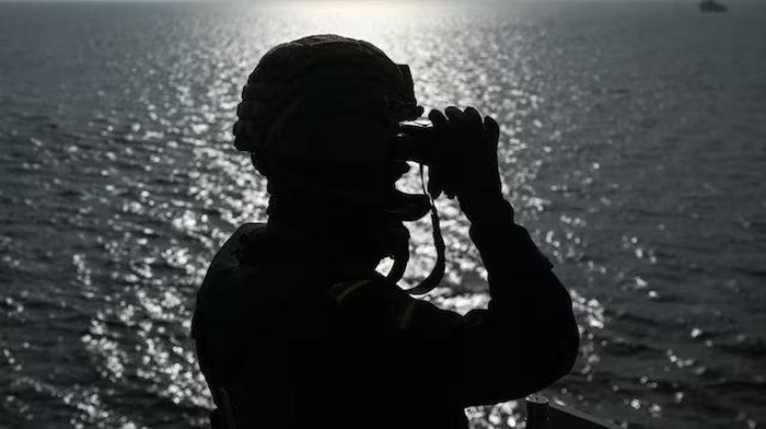 A crew member looks through binoculars in preparation for an air defence exercise on the German Navy supply tender Donau during the multinational naval maneuver Northern Coasts, part of the Quadriga 2025 exercise led by the Bundeswehr and NATO partners to strengthen defense readiness under realistic conditions in the Baltic Sea, off the coast of Kiel, Germany September 2, 2025. REUTERS/Annegret Hilse/File Photo Purchase Licensing Rights