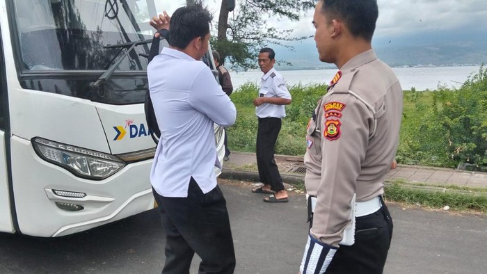 Petugas saat menangkap kondektur bus Perum DAMRI inisial FJ (20) di Pelabuhan Gilimanuk, Jembrana, Minggu (9/11/2025). FJ ditangkap seusai melakukan penusukan di Denpasar. (Foto: Dok. Polres Jembrana)