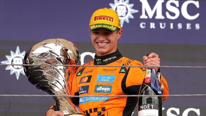 SAO PAULO, BRAZIL - NOVEMBER 09: Race winner Lando Norris of Great Britain and McLaren leaves the podium with his trophy and Champagne during the F1 Grand Prix of Brazil at Autodromo Jose Carlos Pace on November 09, 2025 in Sao Paulo, Brazil. (Photo by Anni Graf - Formula 1/Formula 1 via Getty Images)