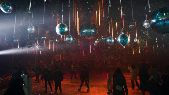 People skate on an ice rink at the art installation 