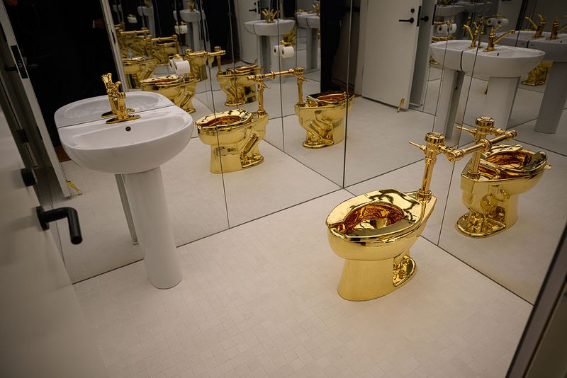 NEW YORK, NEW YORK - NOVEMBER 07: 'America,' the toilet cast from more than 100 kilograms of solid 18-karat gold, by Maurizio Cattelan is displayed during a press preview at Sotheby's on November 07, 2025 in New York City. The estimated value, will be set according to the work's literal weight in gold on the day of auction. Tomorrow, Sotheby's opens its new global headquarters on Madison Avenue in the Marcel Breuer building. The space will be free and open to the public until auction previews conclude. Upcoming sales include The Leonard A. Lauder Collection, The Cindy and Jay Pritzker Collection, The Now and Contemporary Auction, The Exquisite Corpus Auction, and the Modern Day Auction, scheduled for November 18–21, 2025. (Photo by Alexi Rosenfeld/Getty Images)
