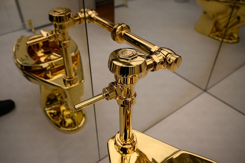 NEW YORK, NEW YORK - NOVEMBER 07: 'America,' the toilet cast from more than 100 kilograms of solid 18-karat gold, by Maurizio Cattelan is displayed during a press preview at Sotheby's on November 07, 2025 in New York City. The estimated value, will be set according to the work's literal weight in gold on the day of auction. Tomorrow, Sotheby's opens its new global headquarters on Madison Avenue in the Marcel Breuer building. The space will be free and open to the public until auction previews conclude. Upcoming sales include The Leonard A. Lauder Collection, The Cindy and Jay Pritzker Collection, The Now and Contemporary Auction, The Exquisite Corpus Auction, and the Modern Day Auction, scheduled for November 18–21, 2025. (Photo by Alexi Rosenfeld/Getty Images)
