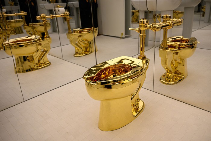 NEW YORK, NEW YORK - NOVEMBER 07: America, the toilet cast from more than 100 kilograms of solid 18-karat gold, by Maurizio Cattelan is displayed during a press preview at Sothebys on November 07, 2025 in New York City. The estimated value, will be set according to the work’s literal weight in gold on the day of auction. Tomorrow, Sotheby’s opens its new global headquarters on Madison Avenue in the Marcel Breuer building. The space will be free and open to the public until auction previews conclude. Upcoming sales include The Leonard A. Lauder Collection, The Cindy and Jay Pritzker Collection, The Now and Contemporary Auction, The Exquisite Corpus Auction, and the Modern Day Auction, scheduled for November 18–21, 2025. (Photo by Alexi Rosenfeld/Getty Images)
