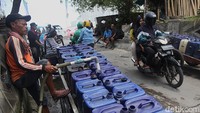 Penjual air keliling mengambil air bersih ke dalam jerigen di kios air bersih di Muara Angke, Jakarta Utara, Selasa (11/11/2025). 