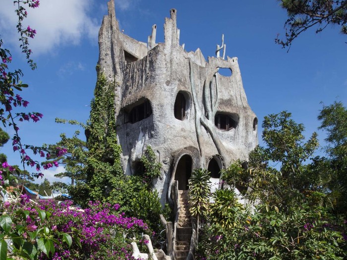 DALAT, LAM DONG, VIETNAM - 2012/05/25: Hang Nga Villa, usually called Crazy House, was designed and built as a personal project by architect Dang Viet Nga. Its original name means Moon Villa as the designer and architect, Ms Dang Viet Nga, wanted to bring people closer to nature.  This is why when exploring through the halls and corridors, you feel like you are inside an artery or intestine.  Watch out or you might just run into a giant spider web!  The house is constructed with these naturalistic themes, interpreted via concrete twists and turns.  Tigers, giraffes and kangaroos made of concrete decorate the gardens, adding to the surreal environment.  . (Photo by John S Lander/LightRocket via Getty Images)