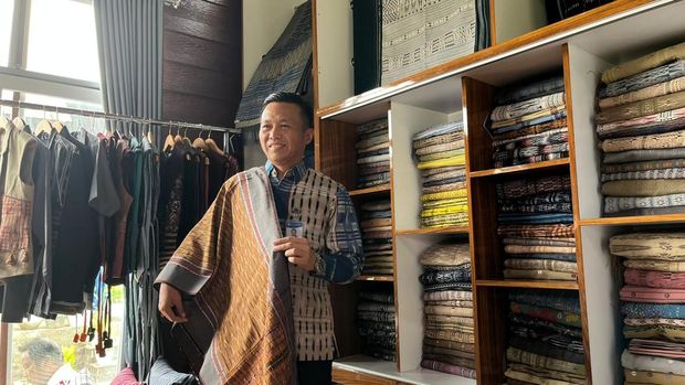 Kepala Perwakilan BI Sibolga ​​​Riza Putera mencoba ulos di Galeri Dame Ulos/Rahajeng Kusumo