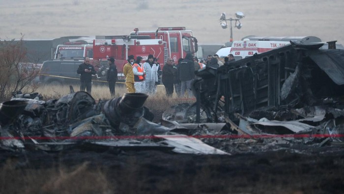 Members of emergency services work at the site of the Turkish C-130 military cargo plane crash near the Azerbaijani border, in Sighnaghi municipality, Georgia, November 12, 2025. REUTERS/Irakli Gedenidze