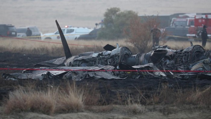 Members of emergency services work at the site of the Turkish C-130 military cargo plane crash near the Azerbaijani border, in Sighnaghi municipality, Georgia, November 12, 2025. REUTERS/Irakli Gedenidze
