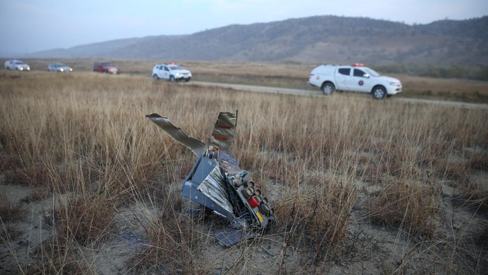 Members of emergency services work at the site of the Turkish C-130 military cargo plane crash near the Azerbaijani border, in Sighnaghi municipality, Georgia, November 12, 2025. REUTERS/Irakli Gedenidze