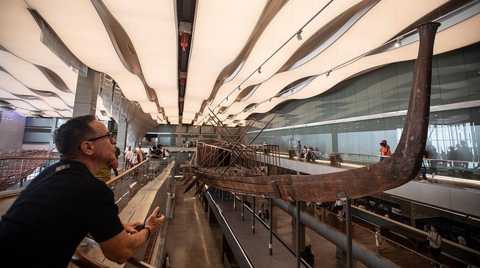 04 November 2025, Egypt, 6th of October: Visitors queue to photograph the Solar Boat of ancient Egyptian King Cheops (2589-2566 BC) on display at the newly opened Grand Egyptian Museum. Photo: Gehad Hamdy/dpa (Photo by Gehad Hamdy/picture alliance via Getty Images)