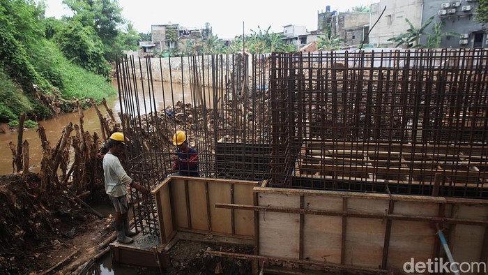 Pekerja mengerjakan proyek pembangunan tanggul dan pintu air di Kali Krukut, Cilandak Timur, Pasar Minggu, Jakarta, Kamis (13/11/2025).