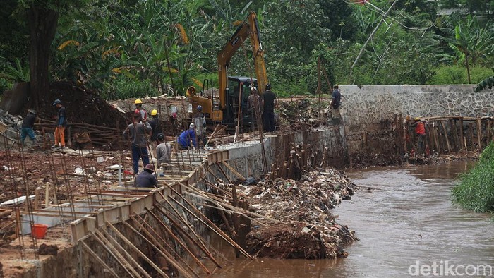 Pekerja mengerjakan proyek pembangunan tanggul dan pintu air di Kali Krukut, Cilandak Timur, Pasar Minggu, Jakarta, Kamis (13/11/2025).