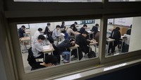 Para siswa menunggu dimulainya ujian masuk perguruan tinggi tahunan di sebuah ruang ujian. Tekanan besar membuat masyarakat Korea memandang Suneung sebagai ujian hidup yang sesungguhnya. REUTERS/Kim Hong-Ji