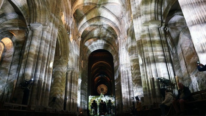 Passers by observe artwork outside Durham Cathedral during the biennial Lumiere in Durham, Britain, November 12, 2025. REUTERS/Lee Smith
