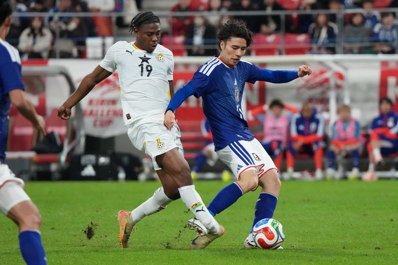 TOYOTA, JAPAN - NOVEMBER 14:  Francis Abu of Ghana breaks his leg as he is kicked by Ao Tanaka of Japan during the international friendly match between Japan and Ghana at Toyota Stadium on November 14, 2025 in Toyota, Aichi, Japan. (Photo by Etsuo Hara/Getty Images)